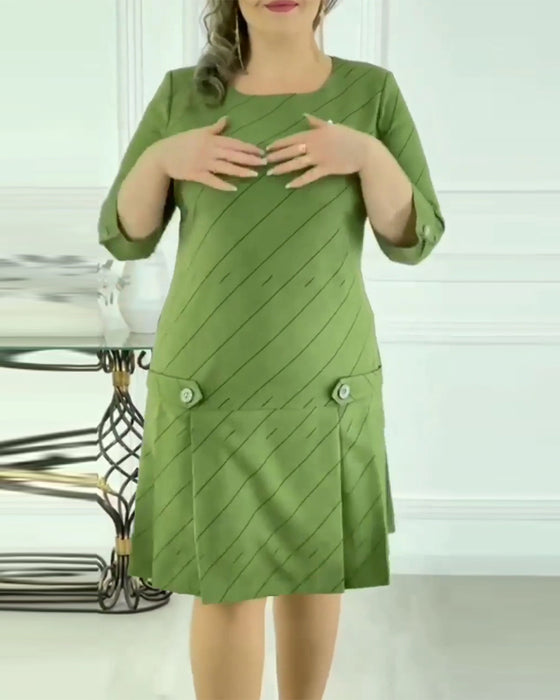 Grøn kjole med plisseret nederdel