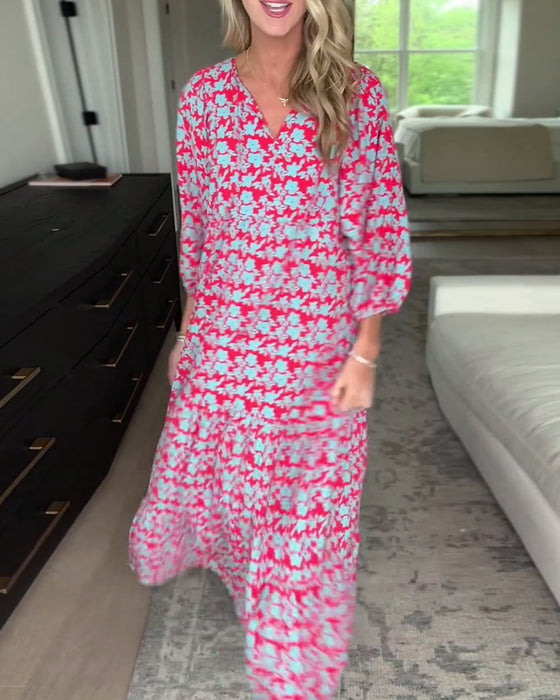 Lang blomsterkjole med V-hals og lanterneærmer