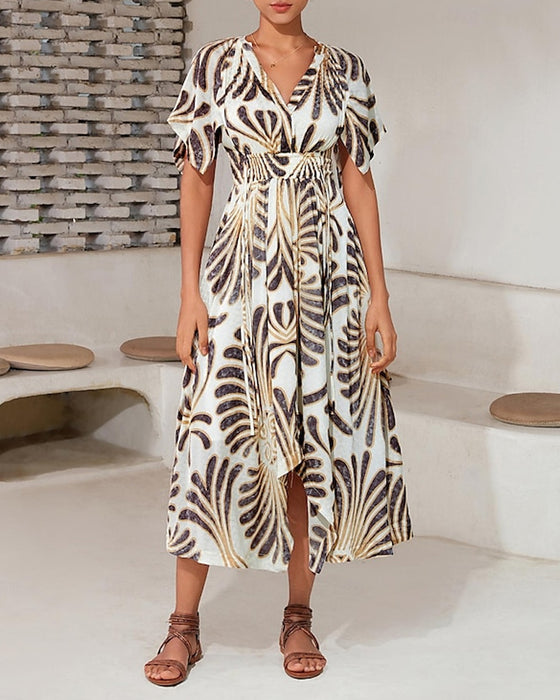 Elegant hvid kjole med gyldent print