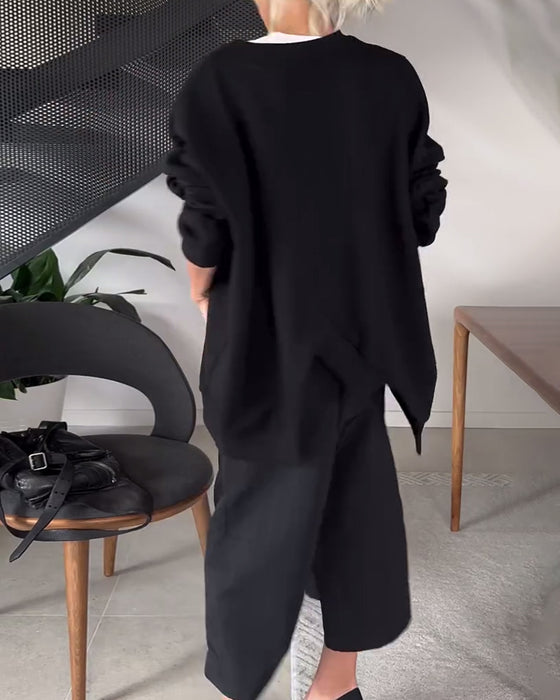 Sort sweater i løs pasform med slids