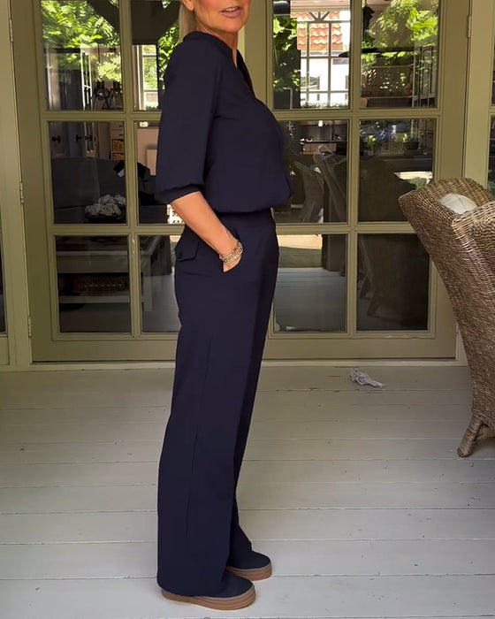 Stilfuld sort buksedragt med V-hals og lommer