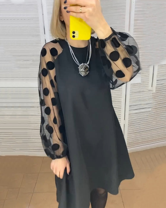 Sort kjole med prikmønstrede net ærmer