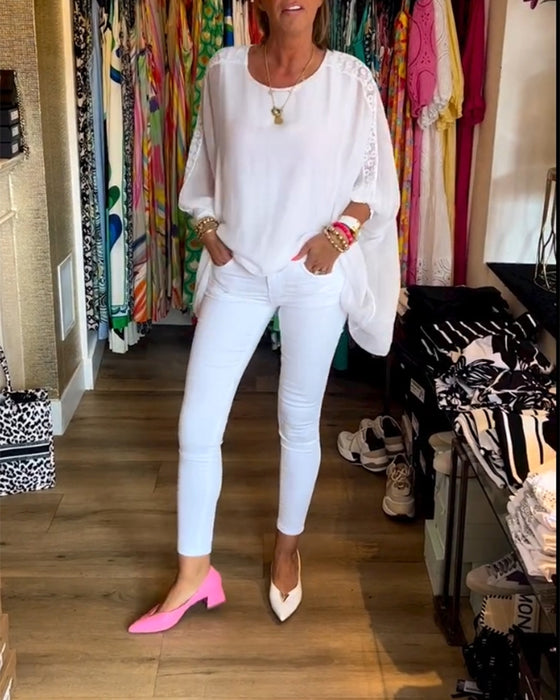 Ensfarvet top i uregelmæssig længde med trekvarte ærmer