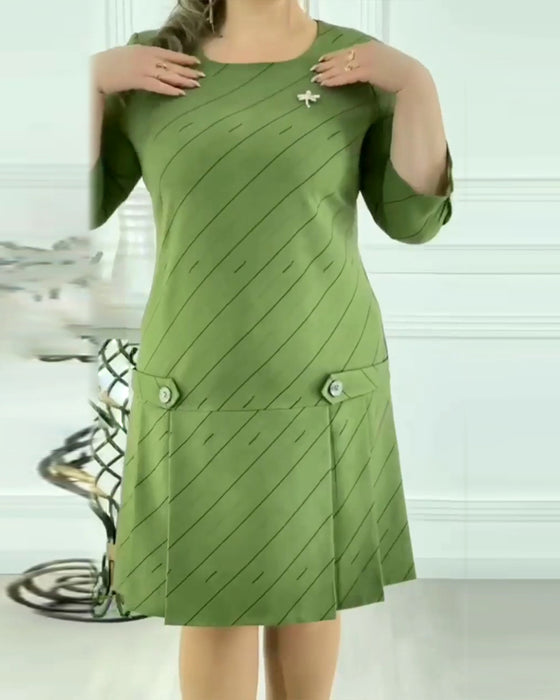 Grøn kjole med plisseret nederdel