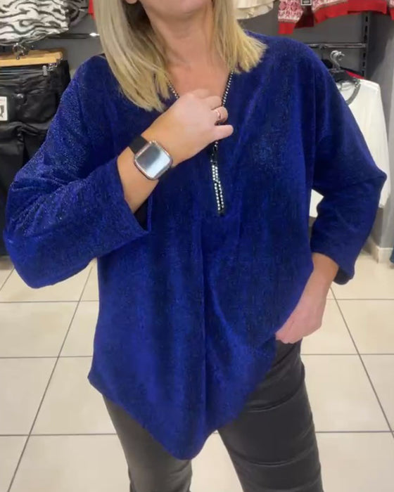 Afslappet top med lange ærmer og lynlås